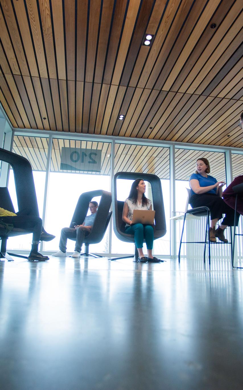 students in chairs in a modern looking space